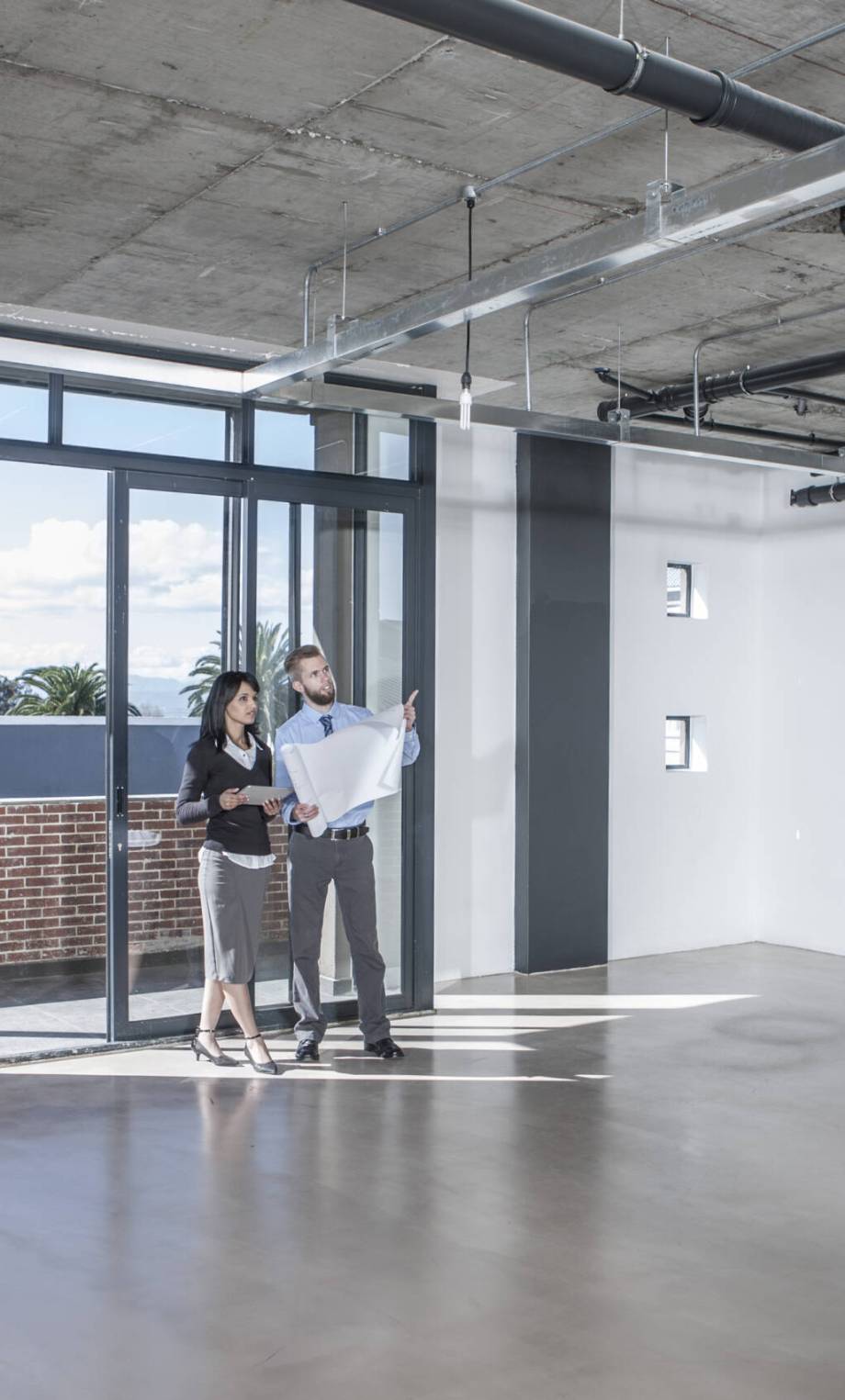 Businesspeople looking at construction plan in new open office